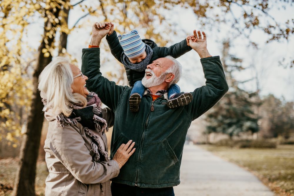 Senior couple with a grandchild in a park